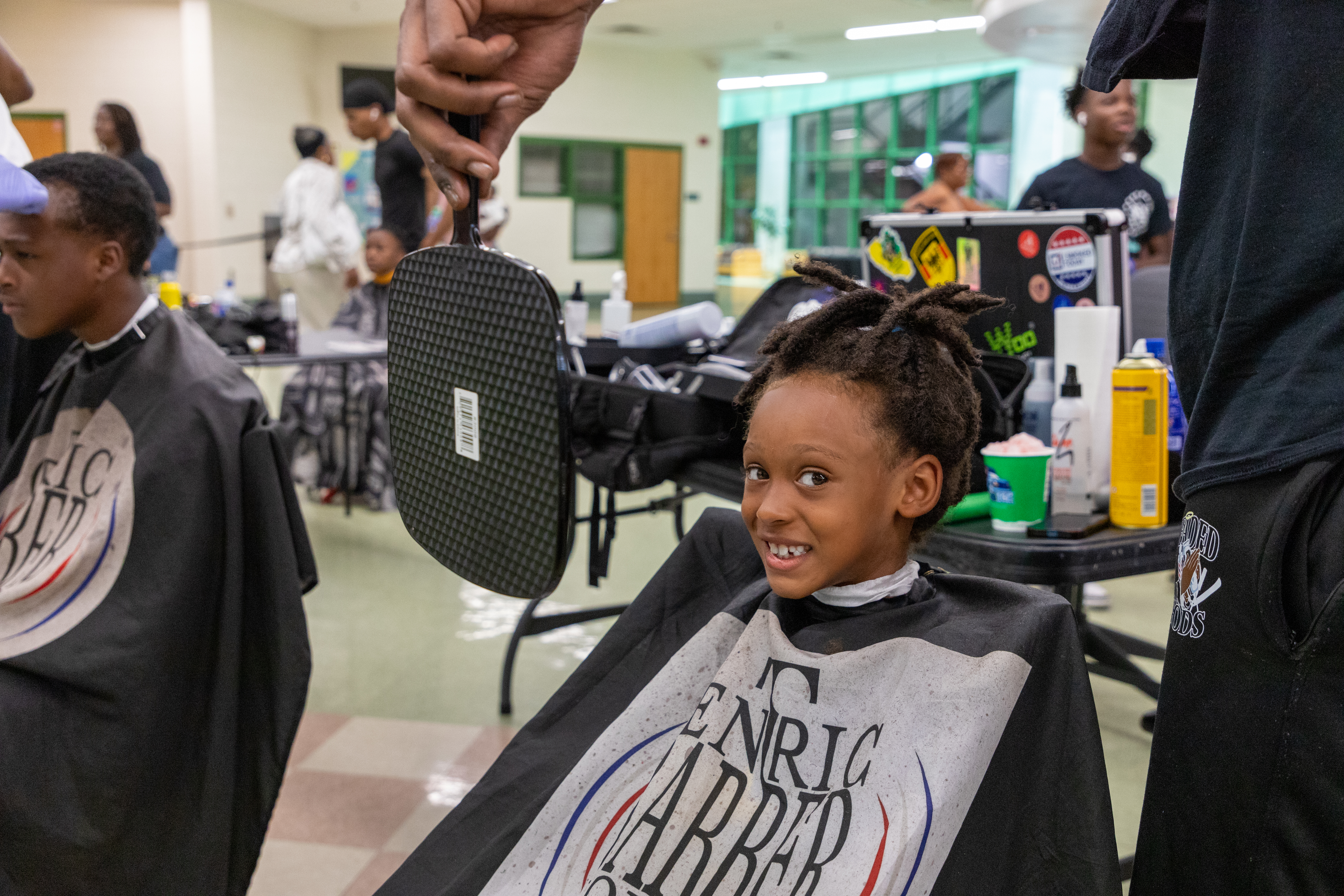 Kids getting haircuts looking in mirror